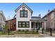 Charming two-story home featuring white siding, black-trimmed windows, and a quaint front porch at 208 N Ridge St, Breckenridge, CO 80424