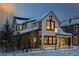 Charming two-story home featuring white siding, black-trimmed windows, and a quaint front porch at dusk at 208 N Ridge St, Breckenridge, CO 80424