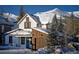 Charming home with snow-covered roof, wood siding, and mountain views at 208 N Ridge St, Breckenridge, CO 80424