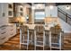 Modern kitchen with white cabinets, stainless steel appliances, and a large center island with seating at 208 N Ridge St, Breckenridge, CO 80424