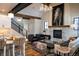 Cozy living room featuring a stone fireplace, exposed wood beams, and stylish furnishings at 208 N Ridge St, Breckenridge, CO 80424