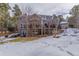 A sprawling backyard featuring a multi-story home, mature trees, a patio, and a well-maintained lawn at 17820 Queensmere Dr, Monument, CO 80132