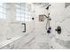 Luxurious bathroom featuring a spacious, marble tiled glass shower with dual shower heads and bench seating at 17820 Queensmere Dr, Monument, CO 80132