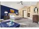Beautiful bedroom featuring neutral walls, vaulted ceilings, a ceiling fan, a fireplace and large windows at 17820 Queensmere Dr, Monument, CO 80132