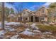 Stunning two-story home featuring a covered entryway, stone accents, and beautiful landscaping at 17820 Queensmere Dr, Monument, CO 80132