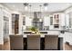 This kitchen has a large island with marble countertops, pendant lighting, and stainless steel appliances at 17820 Queensmere Dr, Monument, CO 80132