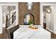 Gourmet kitchen featuring a massive marble island, brick fireplace, and seamless access to the main living areas at 17820 Queensmere Dr, Monument, CO 80132