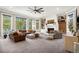Spacious living room with a cozy fireplace, plush seating, and large windows offering scenic views at 17820 Queensmere Dr, Monument, CO 80132