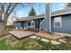Backyard boasts a cozy wooden deck, a neat woodpile, and a well-kept lawn, ideal for enjoying outdoor living at 20908 E Dorado Cir, Centennial, CO 80015