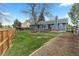 Expansive backyard with a well-maintained lawn, wooden fence, mature trees and a deck, providing a private outdoor space at 20908 E Dorado Cir, Centennial, CO 80015