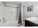 Well-lit bathroom with a sleek vanity, modern fixtures, and a bathtub featuring stylish tile accents and a shower curtain at 20908 E Dorado Cir, Centennial, CO 80015
