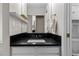 This bathroom features a sleek black countertop, white cabinets, and a large mirror enhancing the bright and modern space at 20908 E Dorado Cir, Centennial, CO 80015