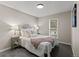 Serene bedroom with soft neutral tones, featuring a comfortable bed, side tables with lamps, and a view to the outside at 20908 E Dorado Cir, Centennial, CO 80015