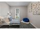 Cozy bedroom featuring a daybed with decorative pillows, a plush beanbag, and ample natural light from the window at 20908 E Dorado Cir, Centennial, CO 80015