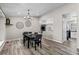 Dining area with neutral walls, decorative lighting, and wood flooring adjacent to open concept kitchen and living room at 20908 E Dorado Cir, Centennial, CO 80015