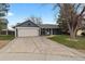 The exterior showcases a quaint blue home with an attached garage, large driveway and mature landscaping at 20908 E Dorado Cir, Centennial, CO 80015