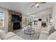 Comfortable living room with stone fireplace and open view to the kitchen at 20908 E Dorado Cir, Centennial, CO 80015