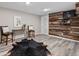 A modern living space is enhanced with a rustic wood accent wall, complemented by sleek flooring and minimalist decor at 20908 E Dorado Cir, Centennial, CO 80015