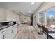 Open-concept living room with kitchen bar, wood floors, and stylish contemporary decor at 20908 E Dorado Cir, Centennial, CO 80015