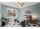 Comfortable bedroom with large window, ceiling fan, neutral color palette, and stylish furnishings at 1674 Fillmore St # Al3, Denver, CO 80206