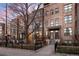 Brick townhomes featuring manicured lawns, black metal fencing, and inviting front entrances at 1674 Fillmore St # Al3, Denver, CO 80206