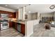 Open kitchen flows into living area, featuring stainless appliances and warm cabinetry at 1674 Fillmore St # Al3, Denver, CO 80206