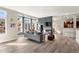 Bright living room features a fireplace, large windows, and sleek wood flooring at 1674 Fillmore St # Al3, Denver, CO 80206