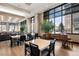 Bright lounge area with ample seating, a piano, and large windows overlooking the neighborhood at 1674 Fillmore St # Al3, Denver, CO 80206