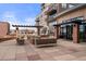Upscale outdoor lounge area with a fireplace, comfortable seating, and a barbecue grill at 1674 Fillmore St # Al3, Denver, CO 80206