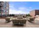 Spacious patio area with comfortable outdoor seating and a fire pit featuring a city skyline view at 1674 Fillmore St # Al3, Denver, CO 80206
