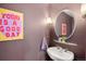 Stylish powder room featuring modern sink, round mirror, and cheerful 'Today is a Good Day' wall art at 1674 Fillmore St # Al3, Denver, CO 80206