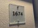 Close-up of a modern, transparent unit number sign displayed outside the building for easy identification at 1674 Fillmore St # Al3, Denver, CO 80206