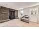 Finished basement featuring a brick fireplace, sitting area, and natural light at 9958 Milwaukee St, Thornton, CO 80229