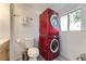 Efficient bathroom setup featuring a stacked washer and dryer unit with updated modern fixtures at 9958 Milwaukee St, Thornton, CO 80229