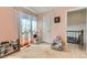 Pink Bedroom with light wood floors, sheer curtains, and access to a connecting room at 9958 Milwaukee St, Thornton, CO 80229