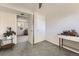 Bright bedroom with a neutral palette, grey carpet, and direct access to the living room at 9958 Milwaukee St, Thornton, CO 80229
