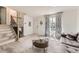 Bright entryway features a staircase, decorative mirror, and a sunlit window with patterned curtains at 9958 Milwaukee St, Thornton, CO 80229
