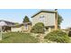 Charming two-story home featuring a brick facade, lush landscaping, and attached garage on a sunny day at 9958 Milwaukee St, Thornton, CO 80229