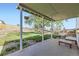 Covered patio overlooking a large fenced backyard with mature trees and green lawn at 9958 Milwaukee St, Thornton, CO 80229