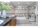 Luxurious bathroom with a soaking tub, glass-enclosed shower, and elegant vanity with granite countertop at 40 Madison St # 103, Denver, CO 80206