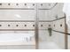 Bright bathroom showcasing a soaking tub and separate glass-enclosed shower with designer tile accents at 40 Madison St # 103, Denver, CO 80206
