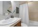 Cozy bathroom featuring a classic tub with shower, complemented by stylish fixtures and neutral tones at 40 Madison St # 103, Denver, CO 80206