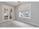 Inviting room with a window letting in natural light, complemented by glass paneled doors and neutral carpeting at 40 Madison St # 103, Denver, CO 80206