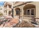 Exterior features arched covered entry, brick walkway, and sculpted, light-colored porch columns at 40 Madison St # 103, Denver, CO 80206
