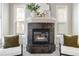 Close-up of the living room fireplace with decorative accents and cozy seating nearby at 40 Madison St # 103, Denver, CO 80206