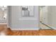 Hallway showing hardwood floors leading to a bedroom, with neutral-colored walls and classic trim at 40 Madison St # 103, Denver, CO 80206