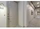 Hallway featuring neutral carpet, modern lighting, art, and exterior door to unit 103 at 40 Madison St # 103, Denver, CO 80206