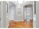 Inviting hallway featuring hardwood floors, arched doorways and neutral paint colors at 40 Madison St # 103, Denver, CO 80206