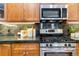 Close-up of the kitchen's stainless steel appliances and dark stone countertops at 40 Madison St # 103, Denver, CO 80206