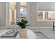 Cozy living room featuring a marble-topped coffee table and views through large windows and glass doors at 40 Madison St # 103, Denver, CO 80206